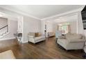 Elegant living room with hardwood floors, neutral paint, and formal dining room at 160 Brookhollow Trce, Alpharetta, GA 30022