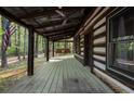 Inviting log cabin porch features a swing and an American flag at 3401 Clay Rd, Austell, GA 30106