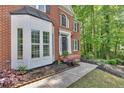 Close-up of brick home with detailed bay window and welcoming front entrance at 4380 Laurian Nw Dr, Kennesaw, GA 30144