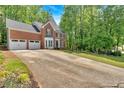 Attractive brick home featuring an extended driveway and well-maintained landscaping at 4380 Laurian Nw Dr, Kennesaw, GA 30144