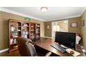Home office with bookshelves, a large desk, and a view of the foyer at 4813 Fernie Ne Ct, Marietta, GA 30068