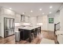 Bright kitchen featuring stainless steel appliances, granite countertops, and a large kitchen island at 5022 Towneship Creek Rd, Roswell, GA 30075