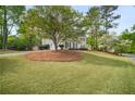 Beautifully landscaped front yard featuring a circular driveway and lush green grass at 899 Fairwood Nw Way, Acworth, GA 30101