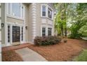 Charming front entrance with a well-lit porch, beautiful door, and landscaped surroundings at 899 Fairwood Nw Way, Acworth, GA 30101