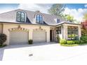 View of the detached three-car garage with stone facade and manicured landscape at 4266 Paces Ferry Road Se, Atlanta, GA 30339