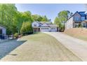 Beautiful home with large front yard, three-car garage, and an inviting driveway, landscaped for privacy and appeal at 110 Legion Dr, Buford, GA 30518