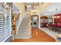Grand two-story foyer with hardwood floors, staircase, and open view to the living spaces at 203 Setters Rdg, Canton, GA 30115
