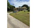 Long driveway leading to a brick home with attached garages and landscaped front yard at 2126 Monterey Dr, Snellville, GA 30039
