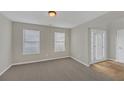 Inviting living room with neutral carpet, light gray walls, and a bright window for ample natural light at 2640 Thunder Basin Way, Douglasville, GA 30135