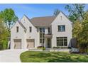 Charming white brick home with a manicured lawn, featuring a two-car garage and well-maintained landscaping at 3290 Dunlop Ne Ct, Atlanta, GA 30319