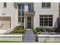 Elegant front entrance with a stone walkway, manicured landscaping, and stylish exterior lighting at 3290 Dunlop Ne Ct, Atlanta, GA 30319