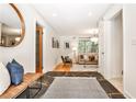 Hallway features wood flooring, leading to a sunlit living space, enhancing a welcoming atmosphere at 1280 Berkeley Rd, Avondale Estates, GA 30002