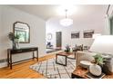 Bright living room featuring hardwood floors, a modern rug, and neutral decor creating a cozy ambiance at 1280 Berkeley Rd, Avondale Estates, GA 30002