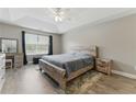 Spacious main bedroom with a king bed, tray ceiling, wood-look floors, ensuite, and lots of natural light at 2154 Windstream Sw Way, Marietta, GA 30060