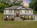 Beautiful two-story home featuring a brick facade, a manicured lawn, and an inviting red front door at 204 Arapahoe Ct, Villa Rica, GA 30180