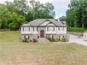 Two-story home boasts stone accents, a well-kept lawn, and a driveway leading to an attached garage at 204 Arapahoe Ct, Villa Rica, GA 30180