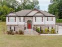 Inviting two-story house with brick and siding, manicured landscaping, and a bright red front door at 204 Arapahoe Ct, Villa Rica, GA 30180