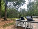 Back deck with grill and lush wooded lot at 4561 N Woodlake Se Ln, Conyers, GA 30013