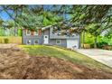 Charming home with gray siding, white trim, shutters, and a well-maintained lawn at 2663 Lowell Dr, Morrow, GA 30260