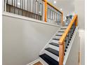 Contemporary staircase design with black and wood railing and modern accents at 2663 Lowell Dr, Morrow, GA 30260