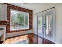 Bright breakfast area featuring hardwood floors and large windows with backyard view at 5221 Huntcrest Sw Pl, Mableton, GA 30126