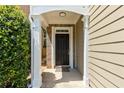 Inviting front entrance with a classic black door, brick accents, and stylish overhead lighting at 7705 Bellmist Dr, Fairburn, GA 30213