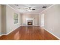 Spacious living room featuring a cozy fireplace and gleaming hardwood floors at 1000 Brushystone Dr, Loganville, GA 30052