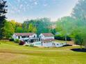 Beautiful backyard featuring a pool, lounge furniture, cabana and well manicured landscaping at 345 Etheridge Rd, Auburn, GA 30011