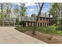 Brick home with an elongated driveway leading up to the house and a detached garage at 3521 Jefferson Township Pkwy, Marietta, GA 30066
