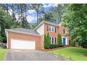 Charming two-story brick home featuring an attached garage and well-manicured lawn at 4213 Schooner Ne Ct, Roswell, GA 30075