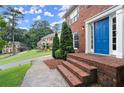 Inviting front entrance with brick steps and a vibrant blue door at 4213 Schooner Ne Ct, Roswell, GA 30075