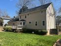 The house features a well-kept lawn and a wooden deck, ideal for outdoor relaxation and entertaining at 7260 Dunhill Ter, Atlanta, GA 30328