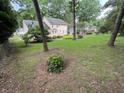 A large, green backyard bordered by mature trees, offering both shade and privacy at 7260 Dunhill Ter, Atlanta, GA 30328