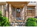 Inviting front porch with a classic arched doorway, brick facade, and manicured shrubbery at 3562 Langley Oaks Se Ct, Marietta, GA 30067