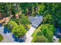 Beautiful aerial view of the home surrounded by mature trees and lush landscaping at 4694 E Glen Ridge E Cir, Winston, GA 30187