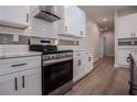 Modern kitchen featuring stainless steel appliances, sleek white cabinets, and tiled backsplash at 4694 E Glen Ridge E Cir, Winston, GA 30187