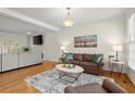 Open-concept living area with hardwood floors, fireplace, and ample seating at 2130 Federal Rd, Roswell, GA 30075