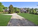 Long driveway leading to a two-story home with mature trees and an expansive front yard at 3704 Wilkins Cir, Powder Springs, GA 30127