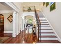 Elegant foyer showcasing hardwood floors, a staircase, and views into the living room at 3704 Wilkins Cir, Powder Springs, GA 30127