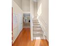 Bright, two-story foyer with hardwood floors leading into a carpeted living space at 877 Ashwood Walk, Decatur, GA 30030