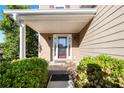 Inviting front porch with decorative glass door framed by manicured greenery at 877 Ashwood Walk, Decatur, GA 30030