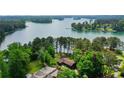 Expansive aerial view of the lake house on a large lot with lake views at 3865 Adams Rd, Cumming, GA 30041