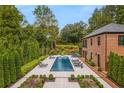 Gorgeous backyard featuring a stunning pool, patio, and lush landscaping at 808 Lullwater Ne Rd, Atlanta, GA 30307