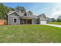 Charming craftsman-style home with gray siding, a manicured lawn, and an attached two-car garage at 82 Lexie Court, Rockmart, GA 30153