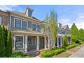 Charming home featuring a well-manicured front yard, inviting front porch and traditional architectural details at 118 Brighton Blvd, Woodstock, GA 30188