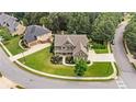Areal view of a large 2 story home with a well manicured lawn in a residential neighborhood at 134 Lakestone Pkwy, Woodstock, GA 30188
