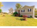Inviting home with a lush lawn and landscaped garden beds at 15 Cobblestone Ct, Douglasville, GA 30134
