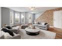 Cozy living room featuring a stone accent wall, hardwood floors, and a neutral color palette at 4413 Pinscher St, Union City, GA 30291