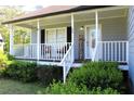 Inviting front porch featuring white railing and a decorative 'Welcome' sign at 3420 Caley Mill Ln, Powder Springs, GA 30127
