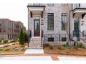 Inviting townhome featuring a brick facade, covered entry, and well-maintained landscaping at 560 Fisher Dr # 48, Alpharetta, GA 30009